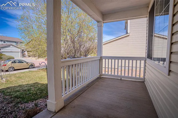 a view of a porch with wooden floor