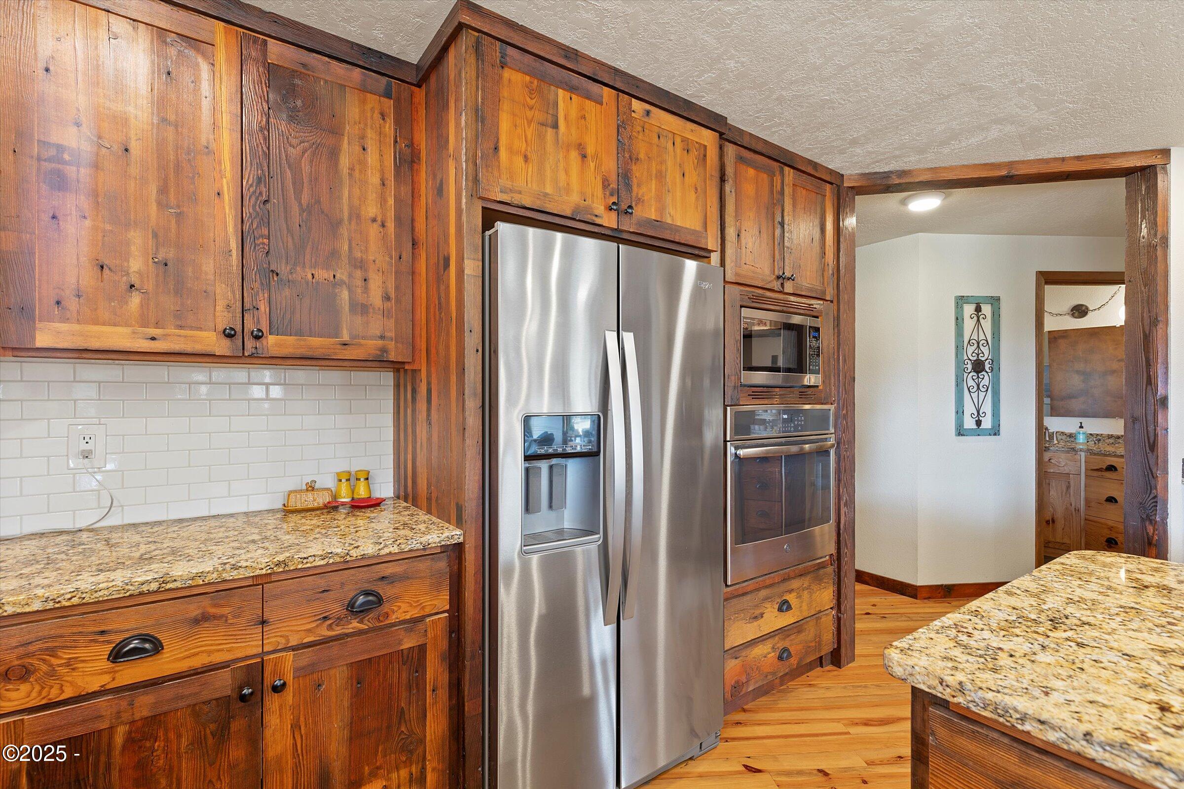 21560 Gooseneck Road Sheridan, OR 97378 - Photo 24 of 63 a kitchen with stainless steel appliances granite countertop a refrigerator and a stove top oven