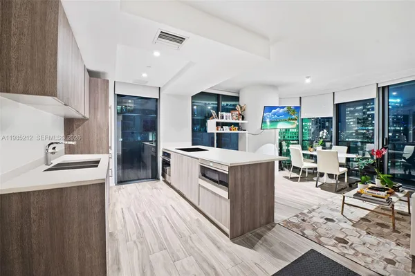 a kitchen with a sink counter top space and stainless steel appliances