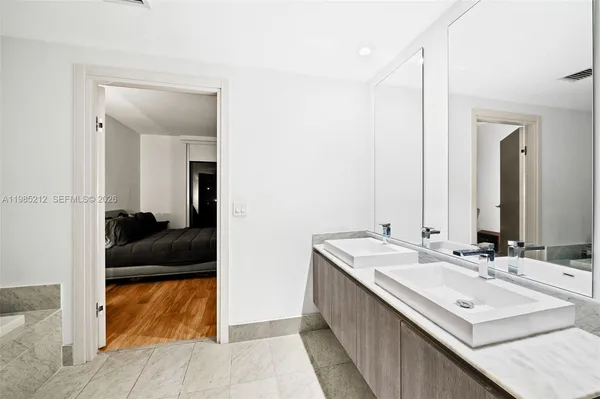a en suite bathroom with a sink and mirror