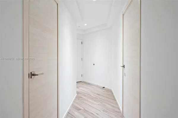 a view of a room with wooden floor