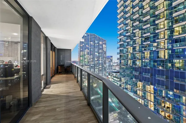 a view of balcony with wooden floor