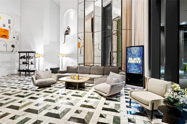 a living room with furniture and large windows