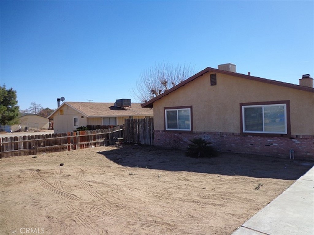 20955 Little Beaver Road, Unit 2 Apple Valley, CA 92308 - Photo 1 of 8 a view of a house with a yard
