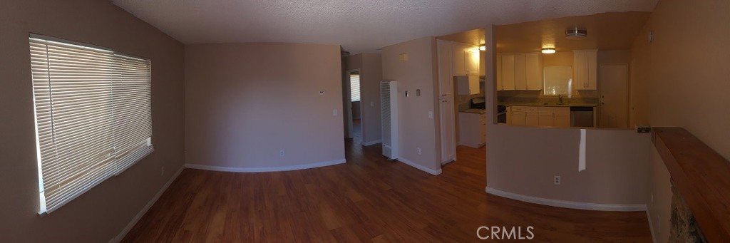 20955 Little Beaver Road, Unit 2 Apple Valley, CA 92308 - Photo 4 of 8 a view of a hallway with wooden floor and staircase