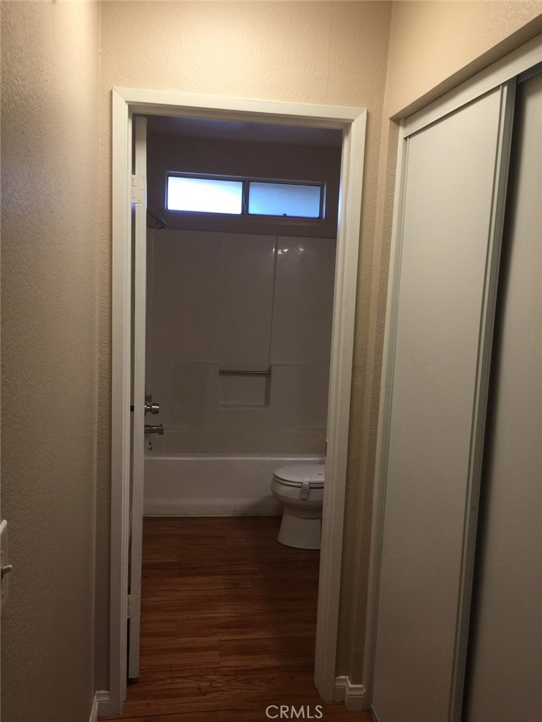 20955 Little Beaver Road, Unit 2 Apple Valley, CA 92308 - Photo 7 of 8 a bathroom with a glass shower door