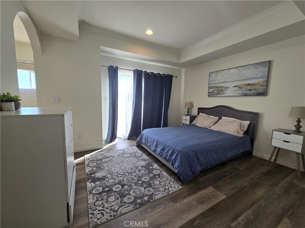 8026 Telegraph Road Downey, CA 90240 - Photo 16 of 26 a bedroom with a large bed and a dresser