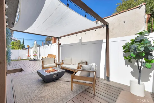 a patio with patio couch and potted plants