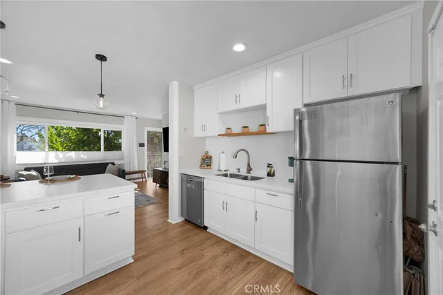 a kitchen with white cabinets and white appliances