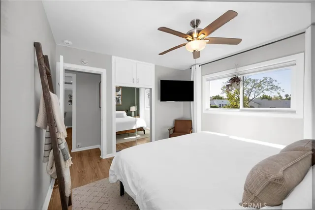 a bedroom with a large bed and a flat screen tv