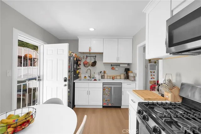 a kitchen with stainless steel appliances a stove a sink a stove and cabinets