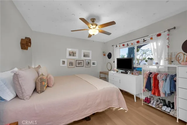 a bedroom with a bed and a flat screen tv