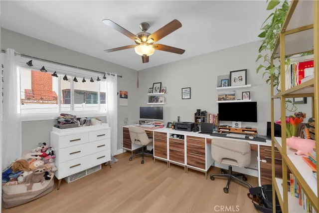 a view of a livingroom with workspace and a window
