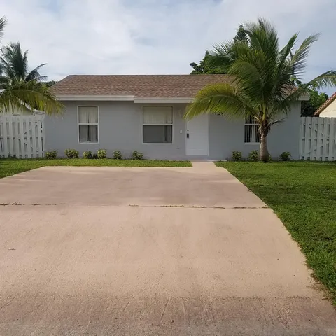 a front view of house with yard and trees