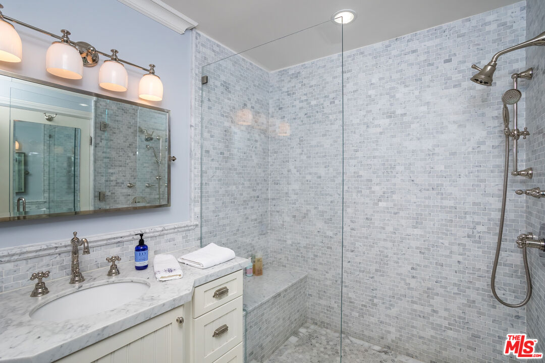 31658 Broad Beach Road Malibu, CA 90265 - Photo 41 of 50 a bathroom with a granite countertop sink a mirror and shower
