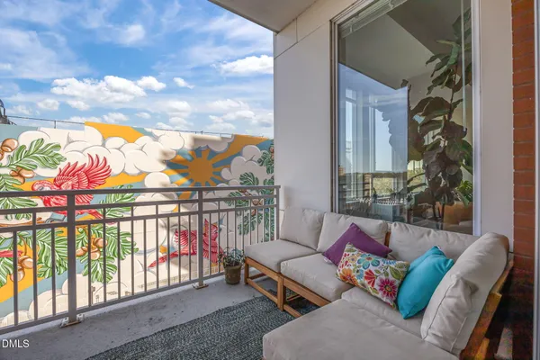 a balcony with furniture and city view