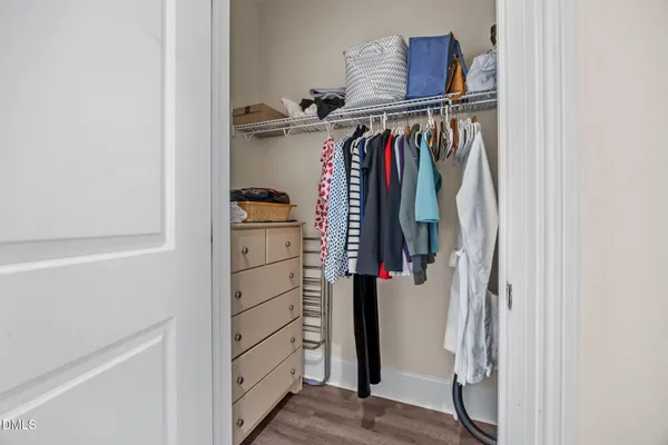 a view of walk in closet with clothes and shoes
