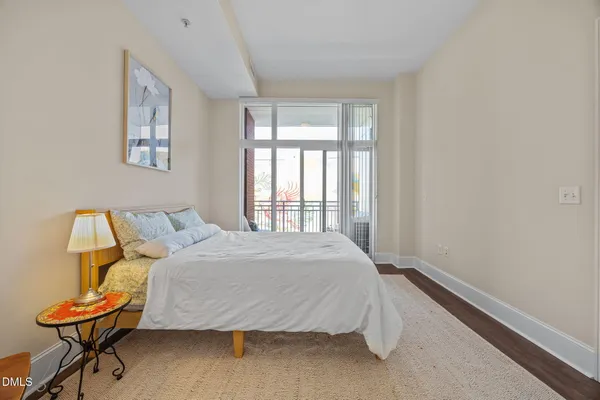 a bedroom with a bed and chair