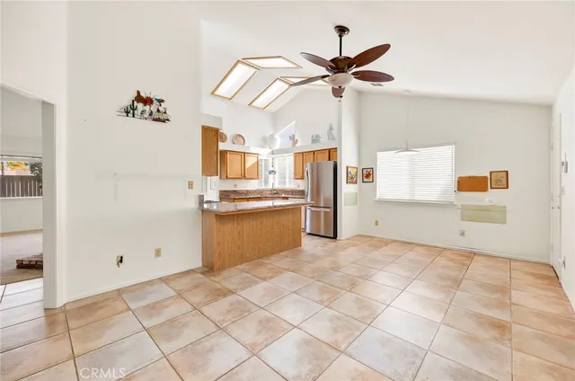 a view of a kitchen with wooden floor and a ceiling fan