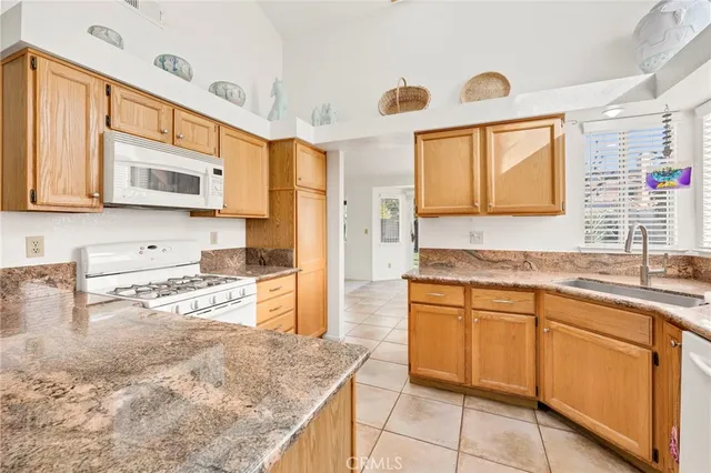 a kitchen with stainless steel appliances granite countertop a sink and a stove