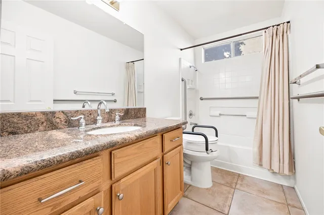 a bathroom with a granite countertop sink a toilet and a mirror