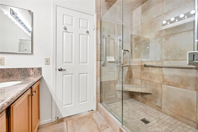 a bathroom with a granite countertop shower mirror and a sink