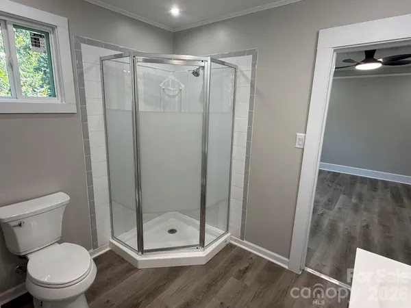 a bathroom with a shower a toilet and a sink