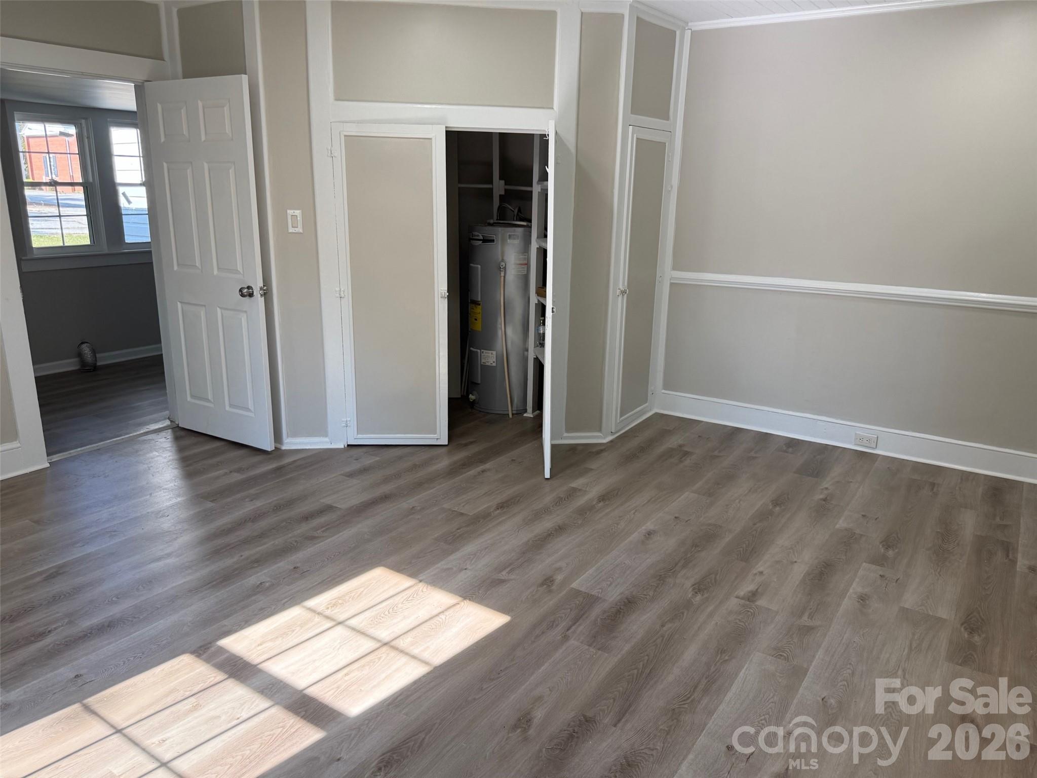 161 Seaboard Street Cheraw, SC 29520 - Photo 4 of 15 an empty room with wooden floor and windows