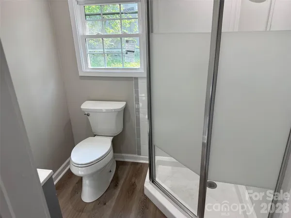 a white toilet sitting next to a window