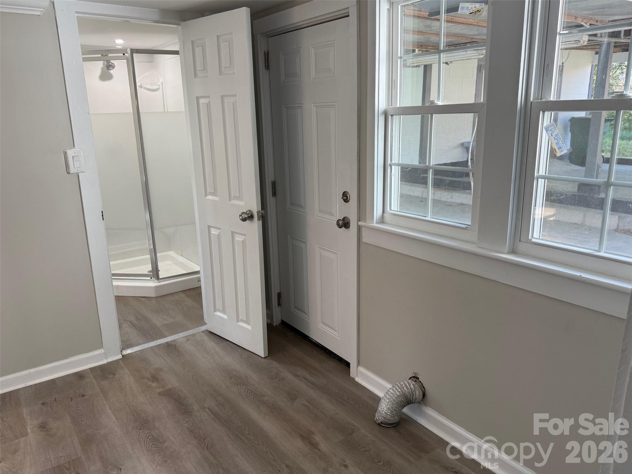 161 Seaboard Street Cheraw, SC 29520 - Photo 7 of 15 an empty room with wooden floor and windows