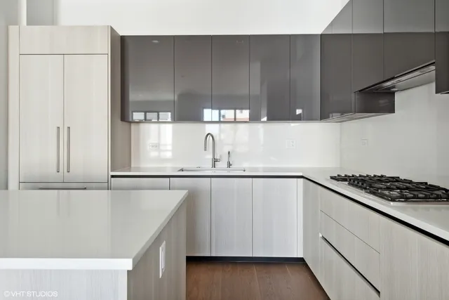 a kitchen with stainless steel appliances cabinets and wooden floor