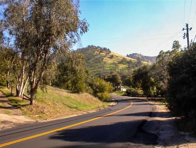 a view of a street with mountains in the background