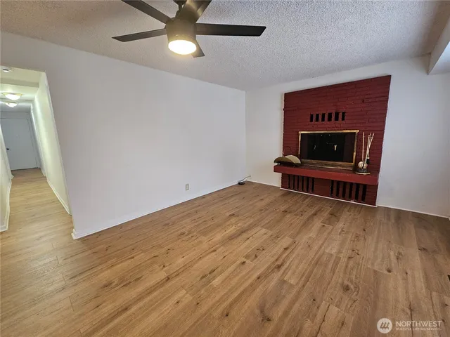 wooden floor in an empty room with a fireplace