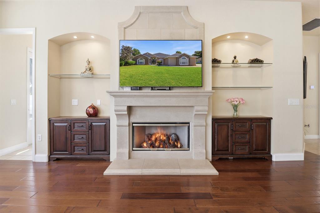 2125 Southeast 25th Loop Ocala, FL 34471 - Photo 25 of 60 a living room with furniture a fireplace and a flat screen tv