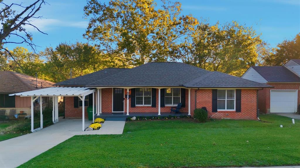 a view of a house with a yard and potted plants
