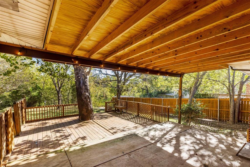 653 Kessler Boulevard Sherman, TX 75092 - Photo 11 of 30 a backyard of a house with large windows and wooden fence