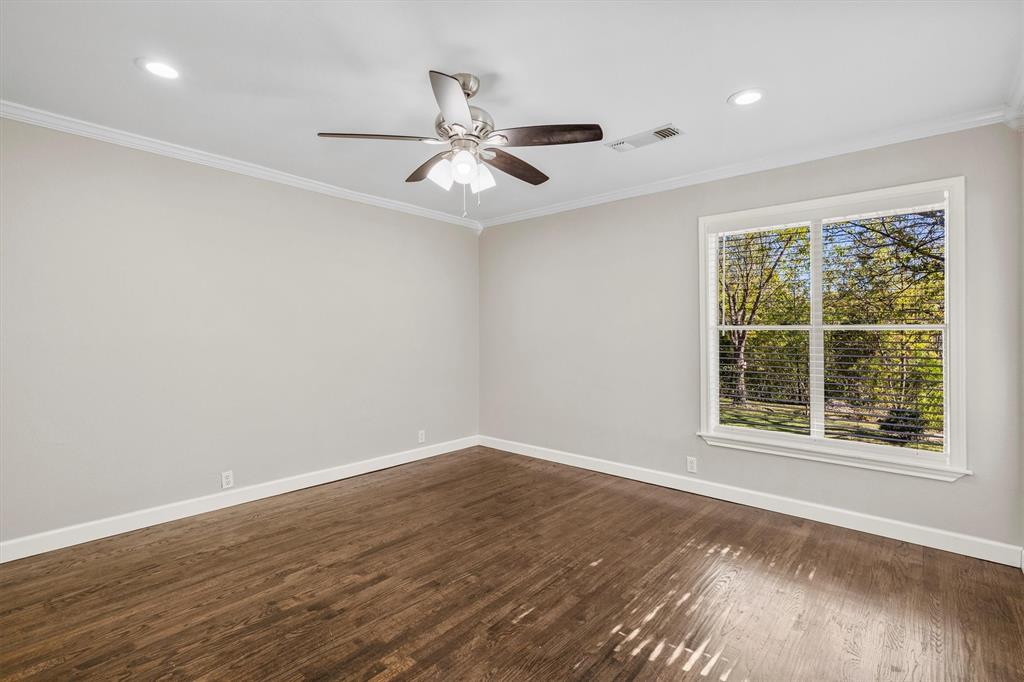 653 Kessler Boulevard Sherman, TX 75092 - Photo 13 of 30 a view of an empty room with wooden floor and a window