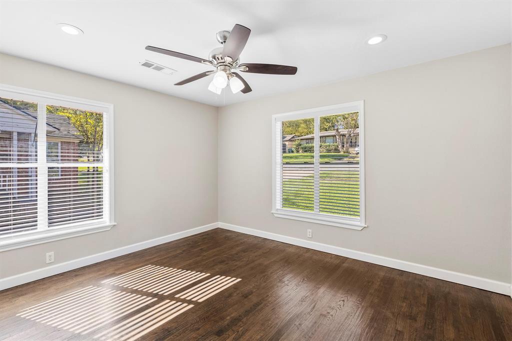653 Kessler Boulevard Sherman, TX 75092 - Photo 17 of 30 a view of an empty room with wooden floor and a window