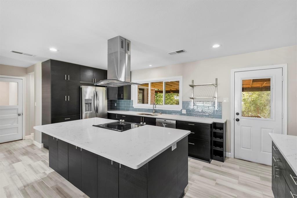 653 Kessler Boulevard Sherman, TX 75092 - Photo 2 of 30 a kitchen with a stove a refrigerator and a sink