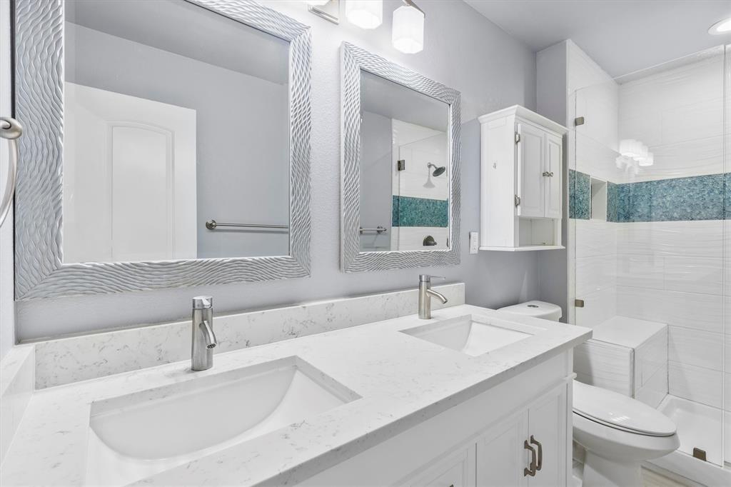 653 Kessler Boulevard Sherman, TX 75092 - Photo 22 of 30 a bathroom with a sink and a toilet