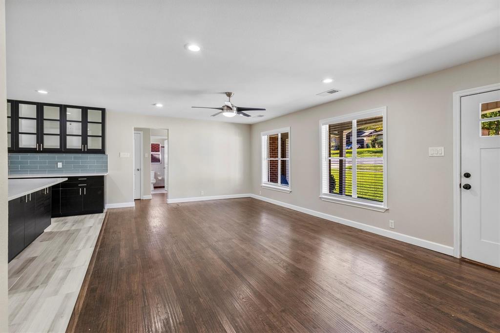653 Kessler Boulevard Sherman, TX 75092 - Photo 27 of 30 a view of an empty room with a window and wooden floor