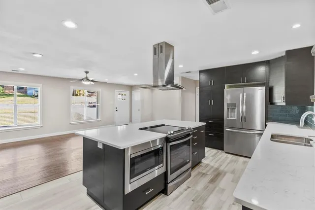 a kitchen with a stove and a refrigerator