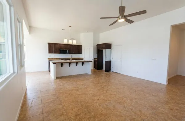 a view of an empty room with a kitchen