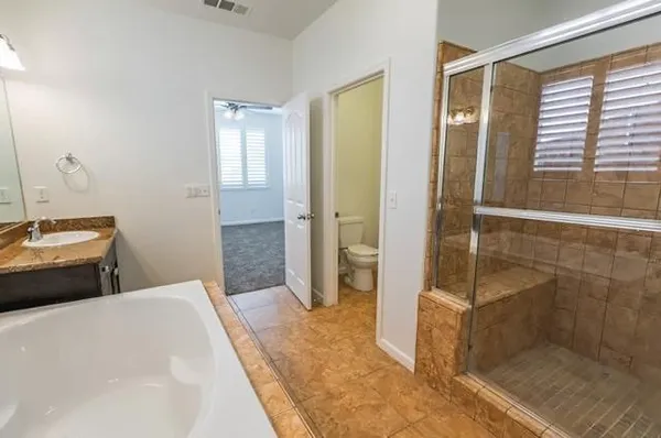 a bedroom with a bed and a shower
