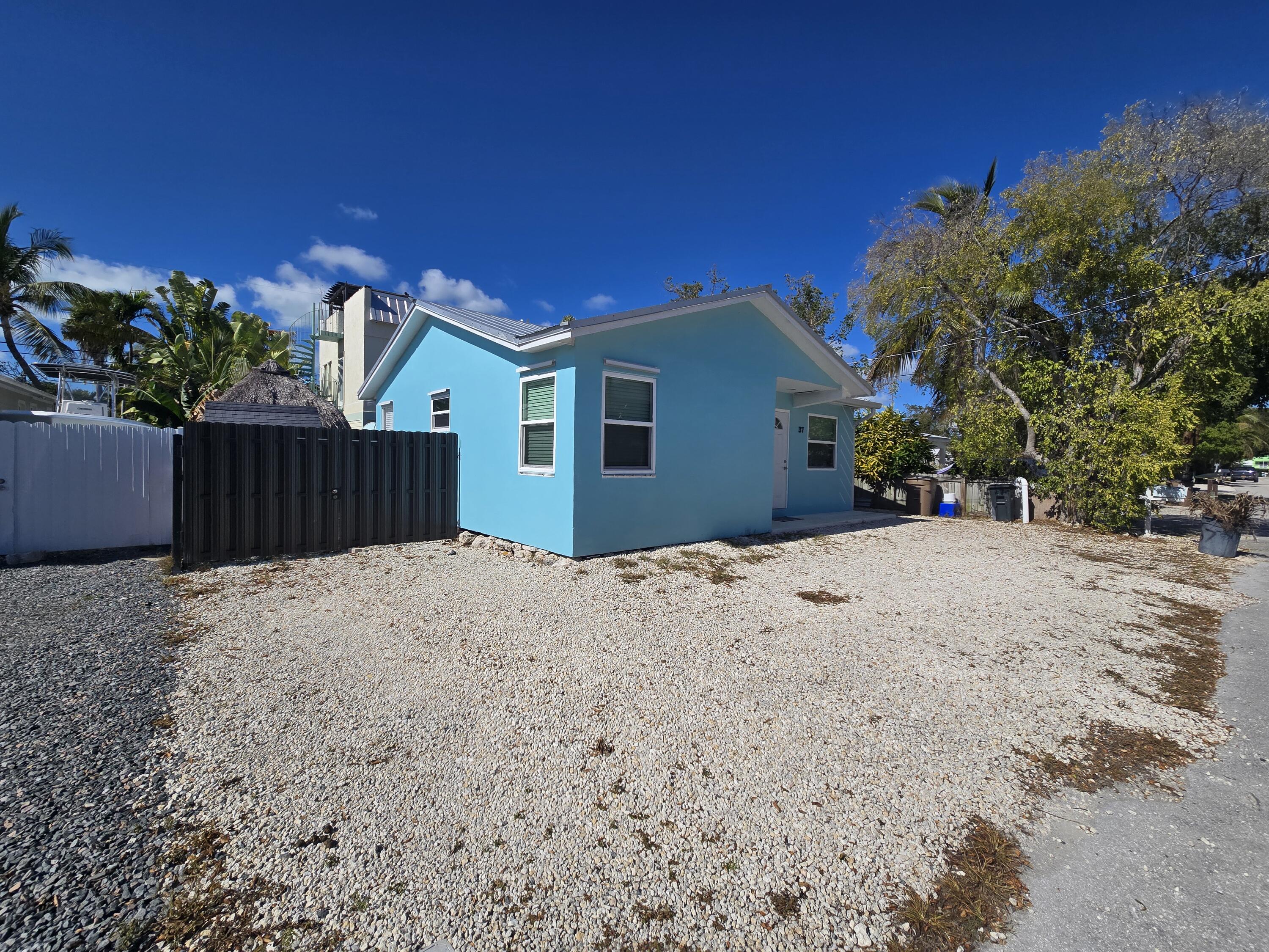 37 Orange Drive Key Largo, FL 33037 - Photo 2 of 12 a view of a backyard of the house