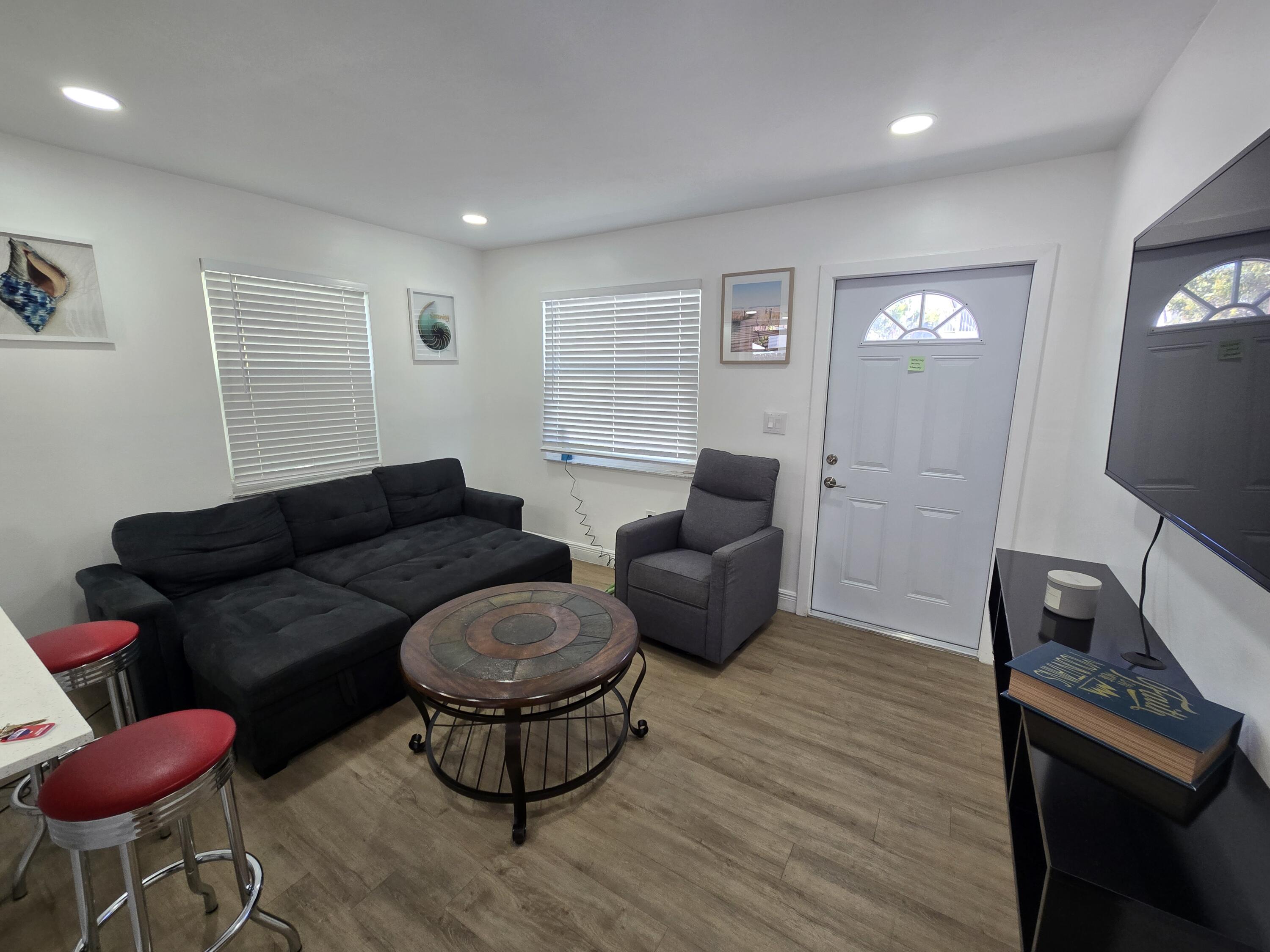 37 Orange Drive Key Largo, FL 33037 - Photo 3 of 12 a living room with furniture a flat screen tv and rug