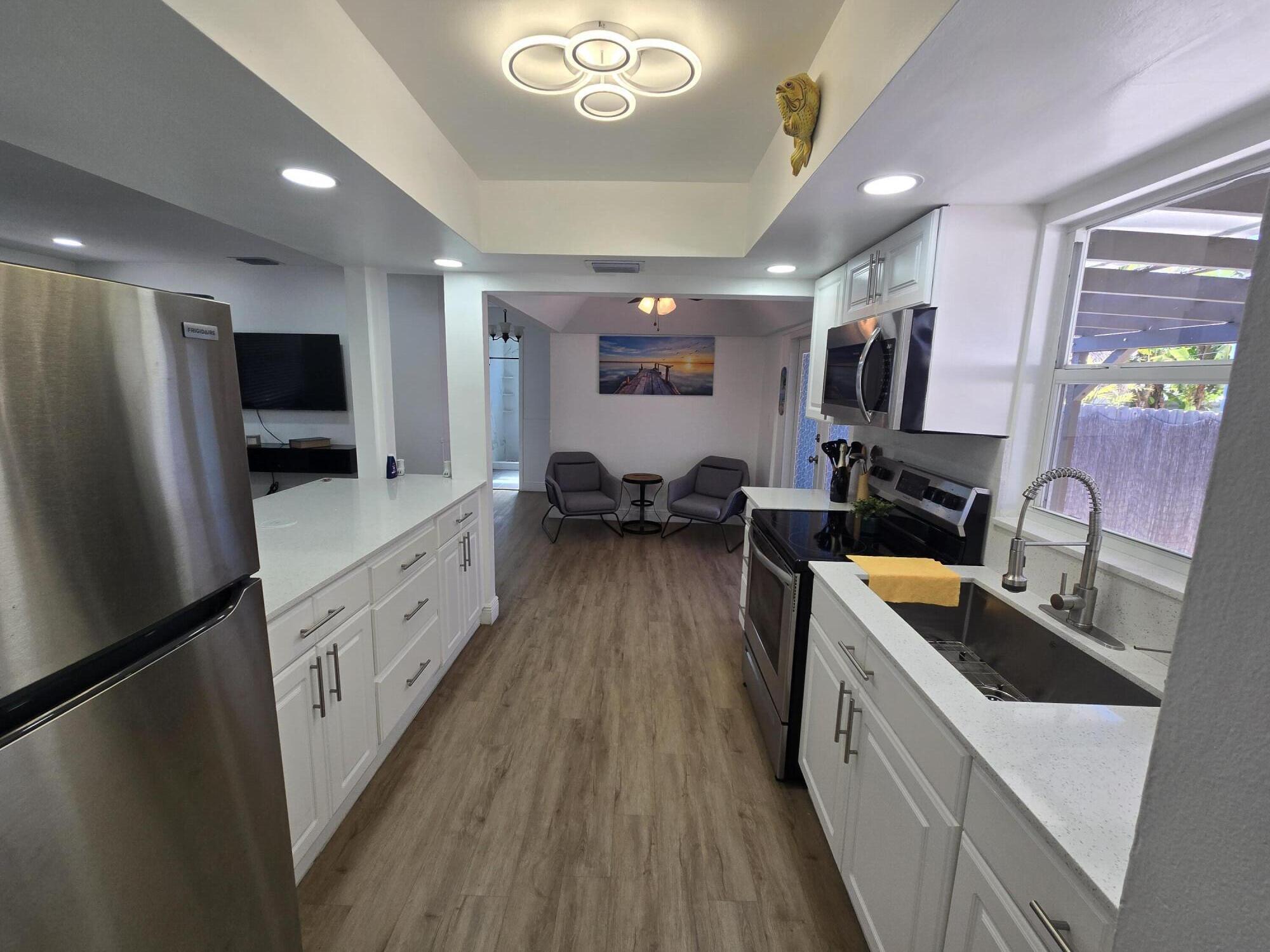 37 Orange Drive Key Largo, FL 33037 - Photo 4 of 12 a kitchen with refrigerator a sink and wooden floor
