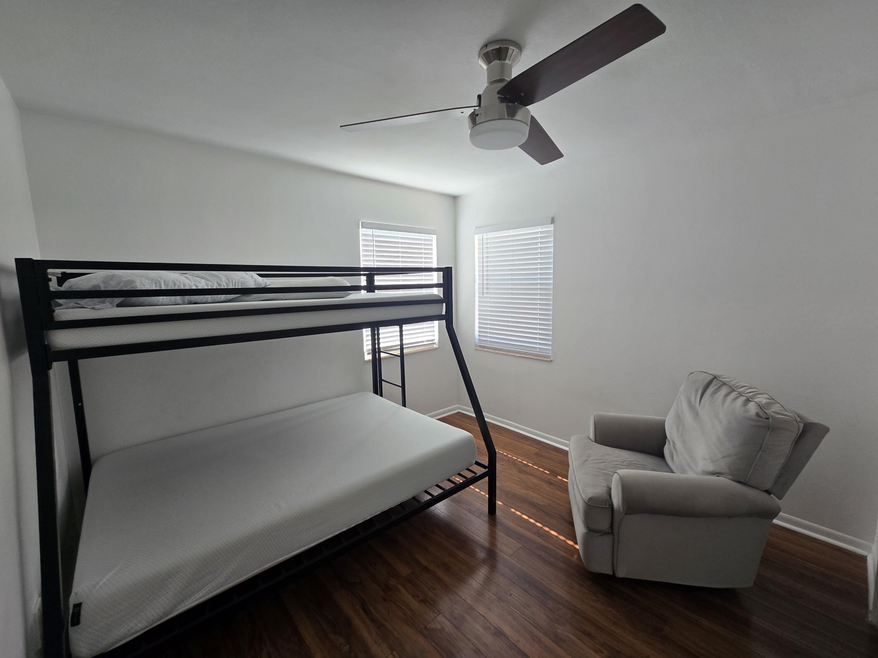 37 Orange Drive Key Largo, FL 33037 - Photo 8 of 12 a bedroom with a bed and a ceiling fan