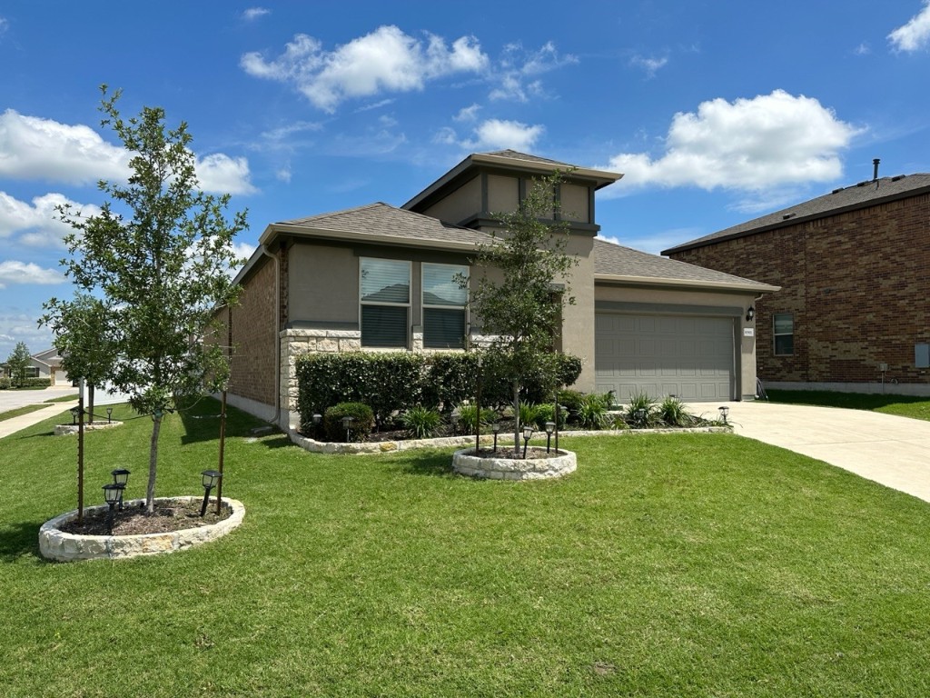 a front view of a house with a yard