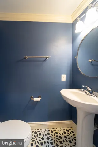 a bathroom with a sink a mirror and a toilet